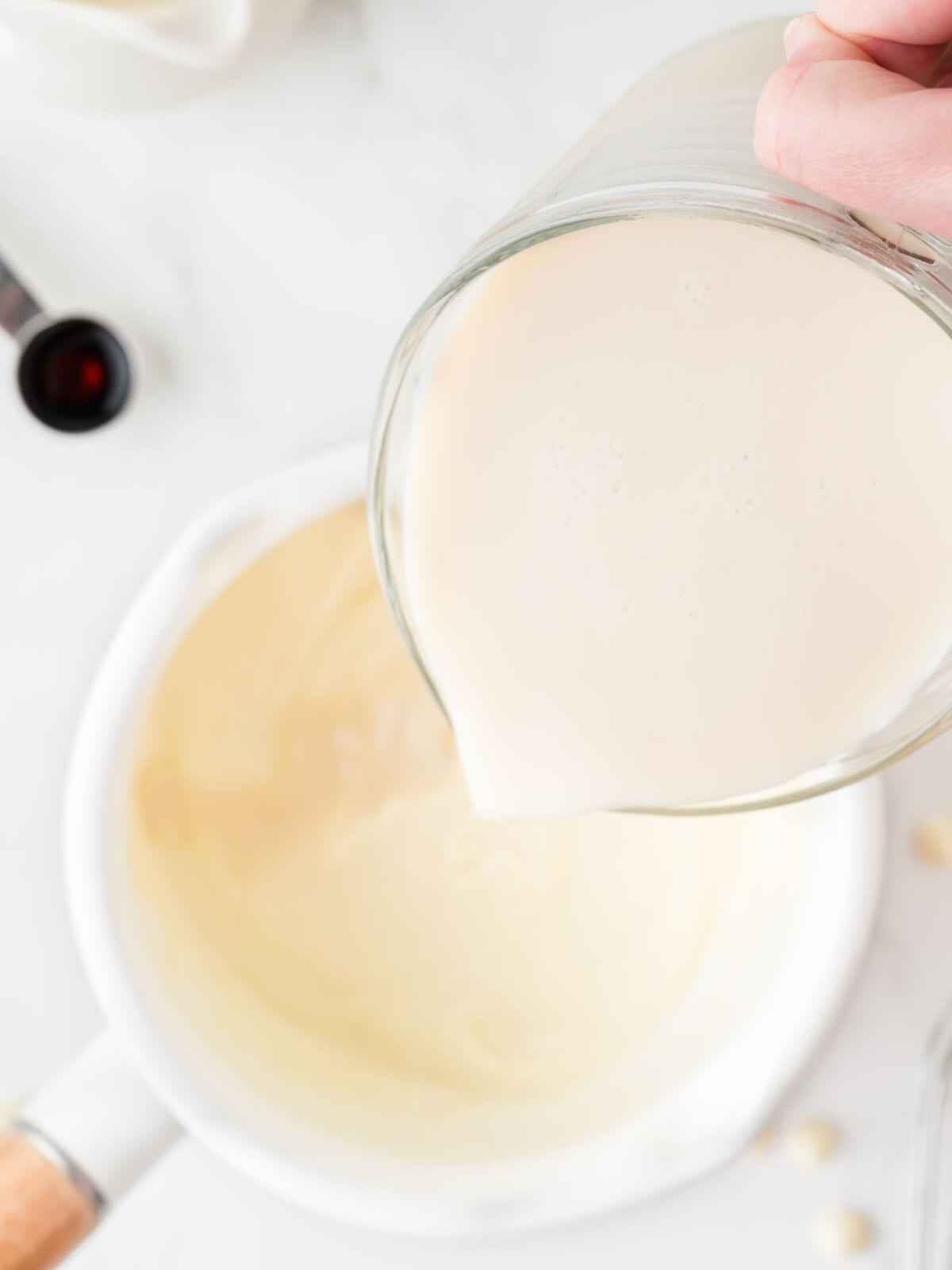 Cream added to melted white chocolate.