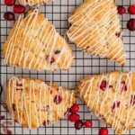 White chocolate cranberry scones drying on rack.