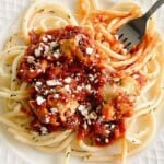 Baked meatballs and pasta twirled with a fork.