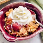 Cherry cobbler dump cake with almond whipped cream on top.