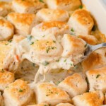 Spoon holding up chicken and biscuits.