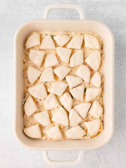 Canned biscuits arranged on top of casserole.