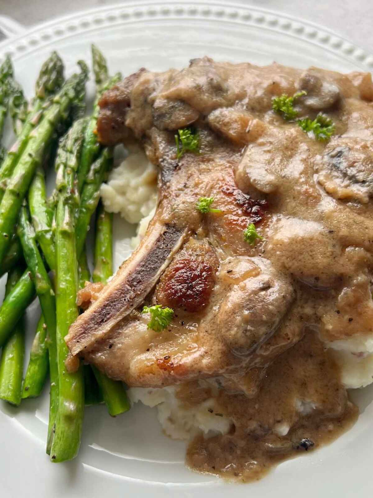 Mushroom gravy over pork chop on mashed potatoes.