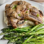 Dutch oven pork chop with mushroom gravy and lemon asparagus with mashed potatoes.