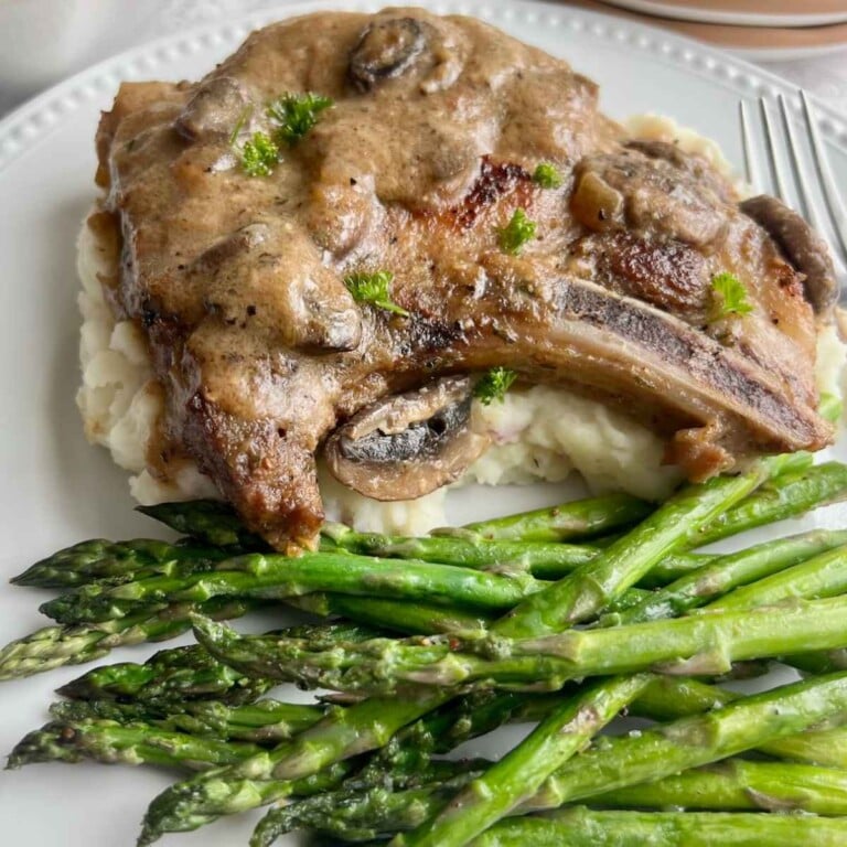 Dutch oven pork chop with mushroom gravy and lemon asparagus with mashed potatoes.
