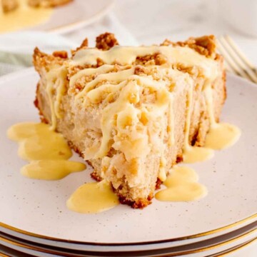 Irish Apple Cake with Vanilla Custard Sauce on a stack of plates.