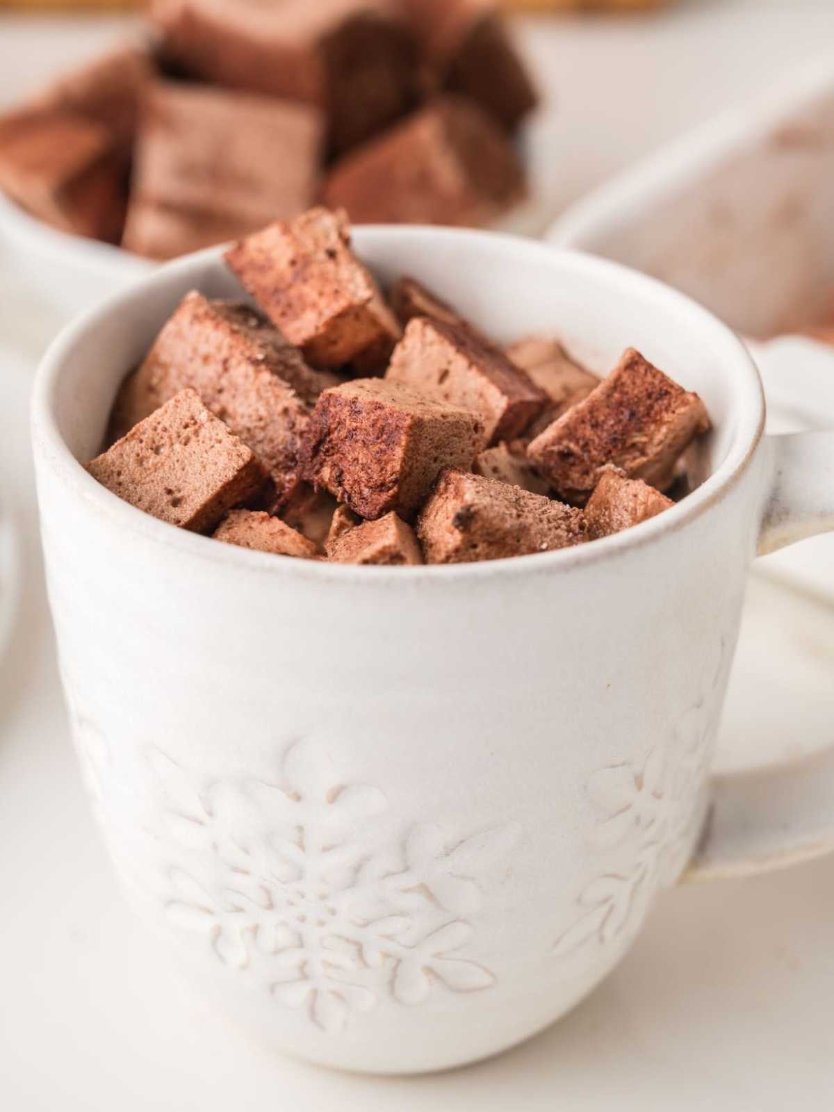 A cup of mini chocolate marshmallows.