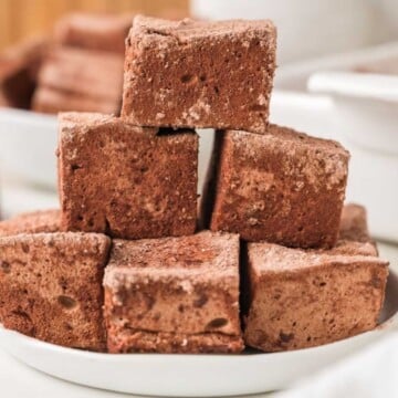 A stack of homemade chocolate marshmallows on a white plate.