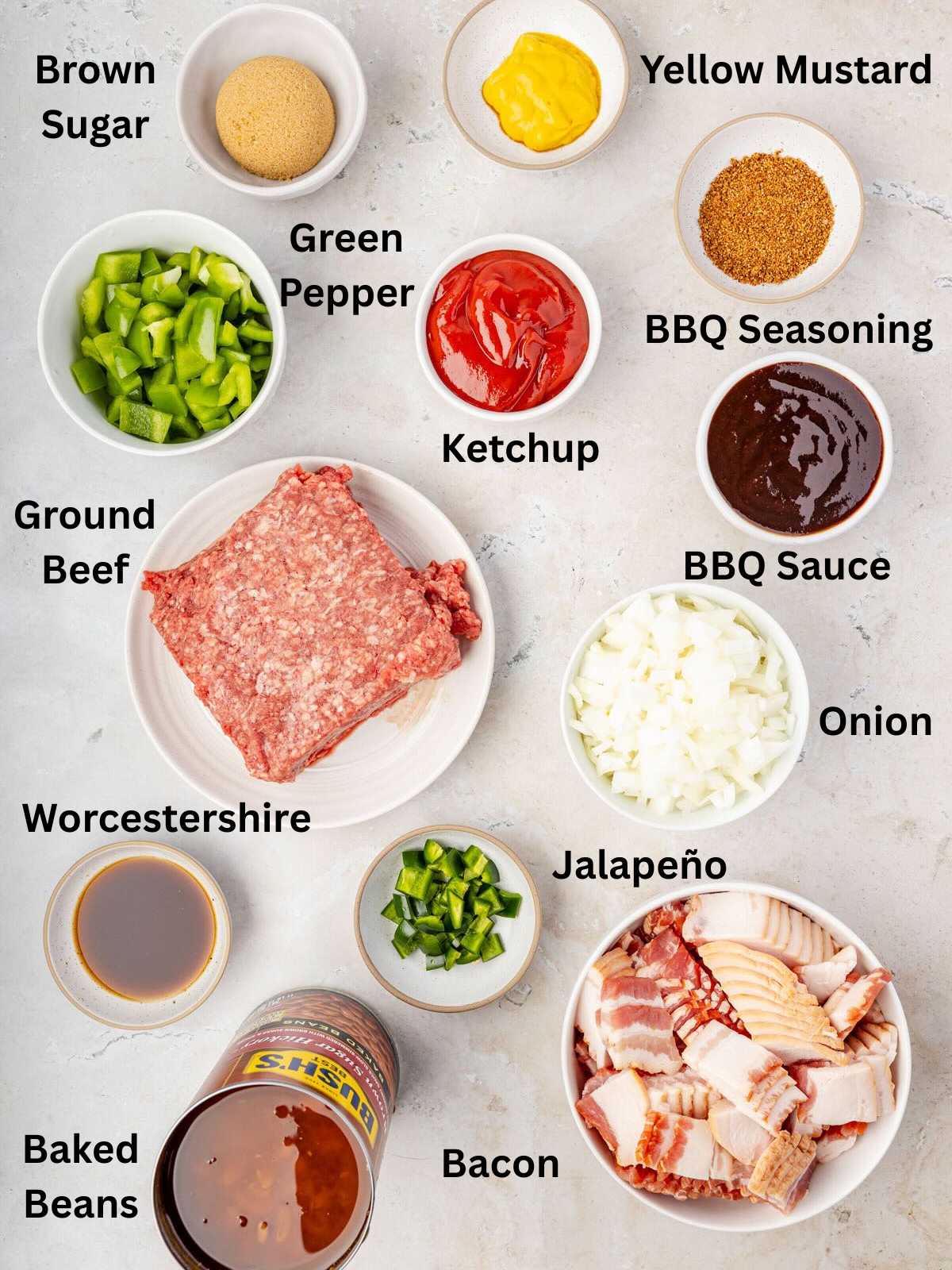 Ingredients for Cowboy baked beans: ground beef, bacon, beans, peppers, onion, seasonings, ketchup, BBQ sauce.